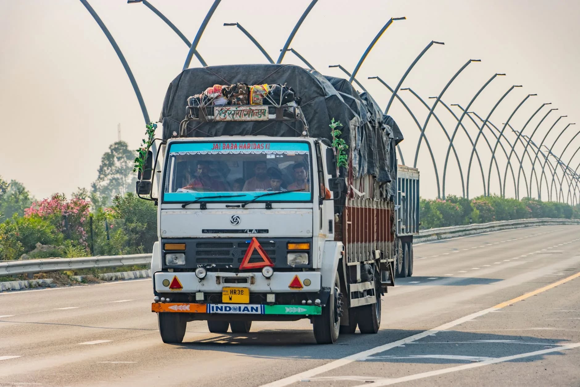 White truck on Deeg expressway, Uttar Pradesh, India transporting goods.