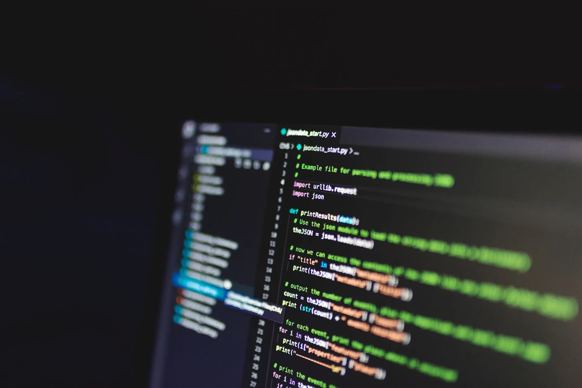 Programming code on a computer screen in a dark room, showcasing technology and IT expertise.